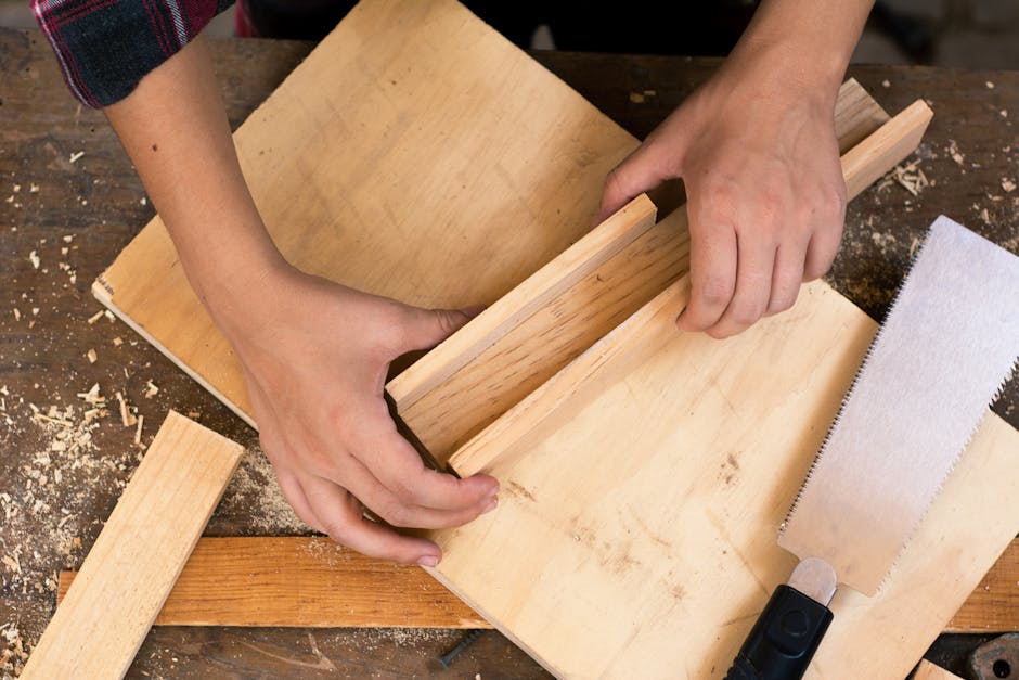 Close-up of hands crafting wood with tools, perfect for DIY carpentry and craft projects.