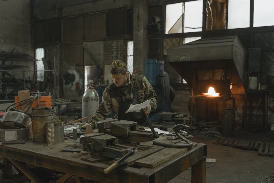 An experienced blacksmith working meticulously in a bustling forge, surrounded by tools and glowing metal.