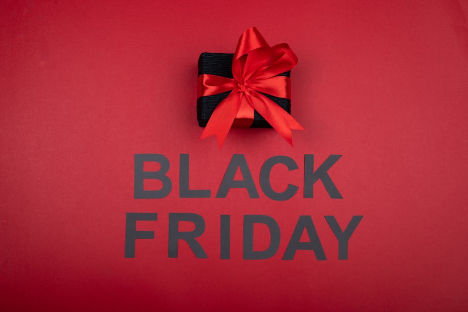 Black gift box with red ribbon, perfect for Black Friday sales promotions.