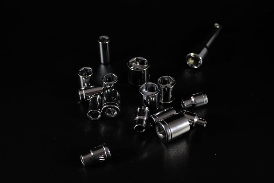 Collection of stainless steel socket wrenches on a sleek black surface, emphasizing tools and hardware