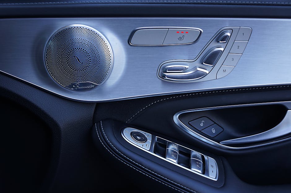Sleek modern Mercedes-Benz car door showing speaker and control panel features.