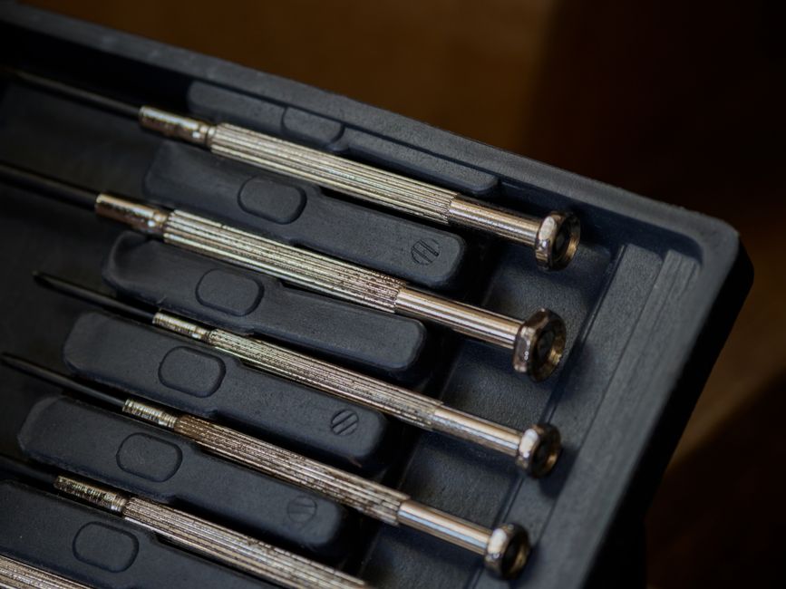 Close-up shot of a precision screwdriver set in a black case, ideal for detailed work.