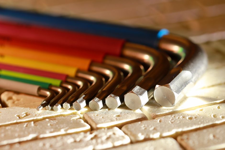 Vibrant set of hex keys arranged on a textured surface, highlighting different sizes.