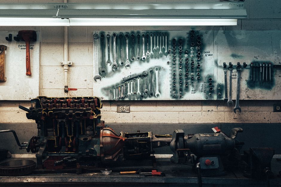 A well-organized workshop scene featuring tools and machinery on a workbench.