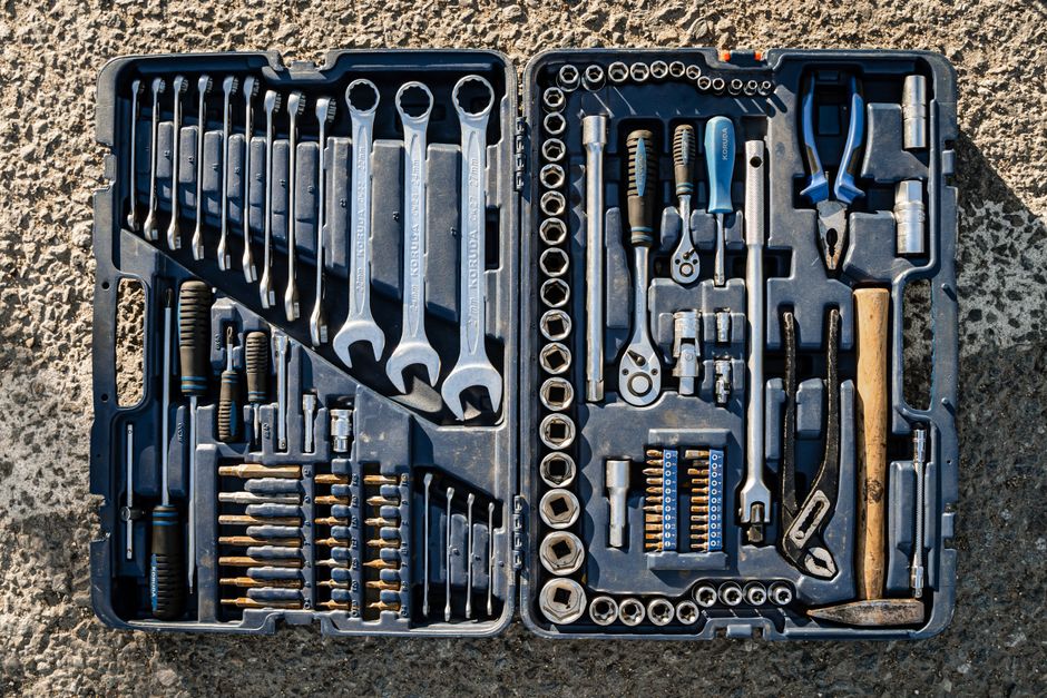 Flat lay of an organized toolbox with a variety of essential hand tools.