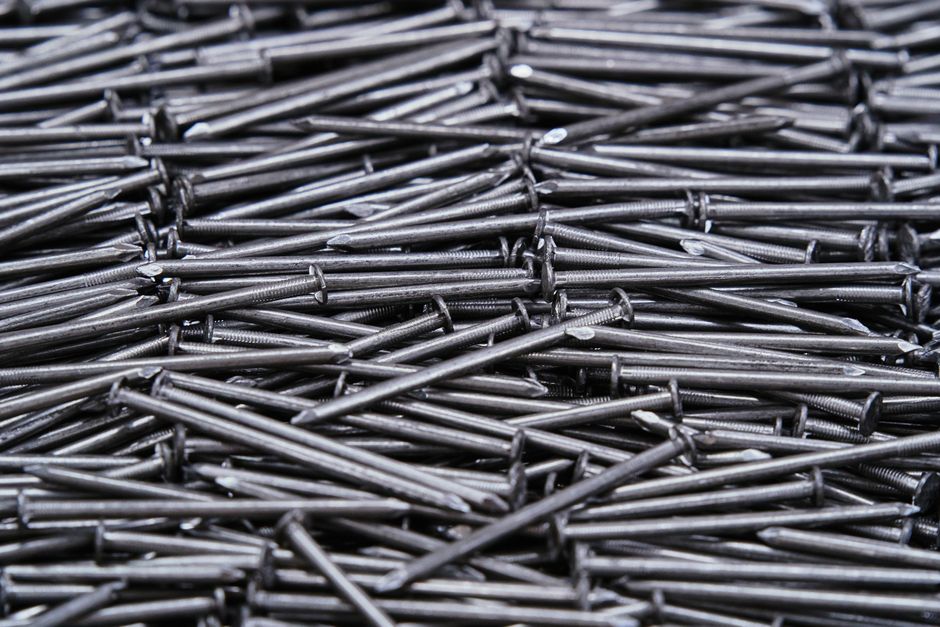 High-resolution image of numerous metal nails arranged closely together.
