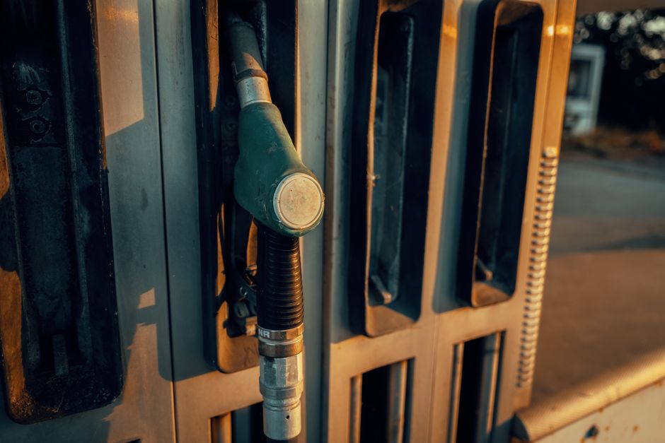 A detailed view of a gas pump nozzle during sunset in Österreich, highlighting industrial design.