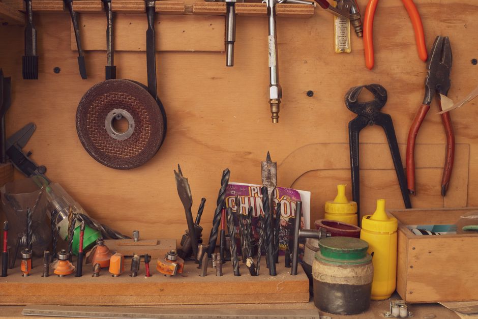 A variety of carpentry tools and equipment neatly arranged in a traditional Mexican workshop.