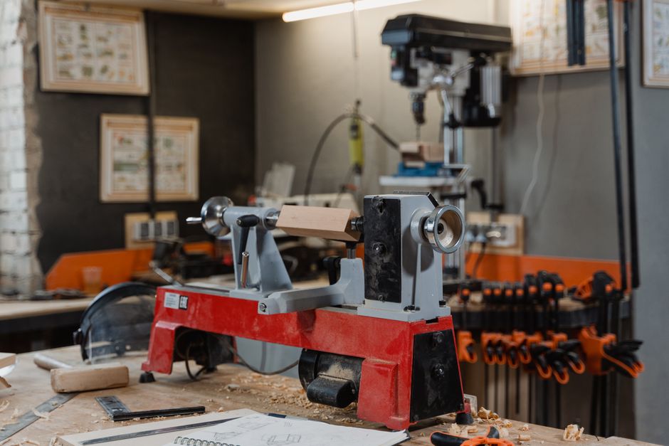 A well-equipped woodworking workshop with a lathe and tools on the workbench.
