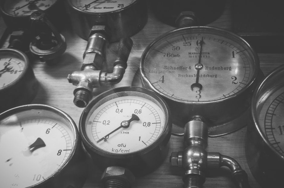 Black and white photo of vintage pressure gauges showing various measurements.