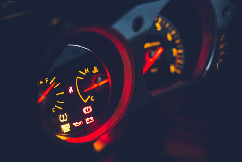 Closeup of oil pressure gauge with arrows and scale on instrument panel in modern auto