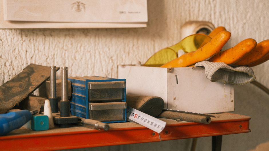 Collection of vintage tools on a wooden table indoors with a retro vibe.