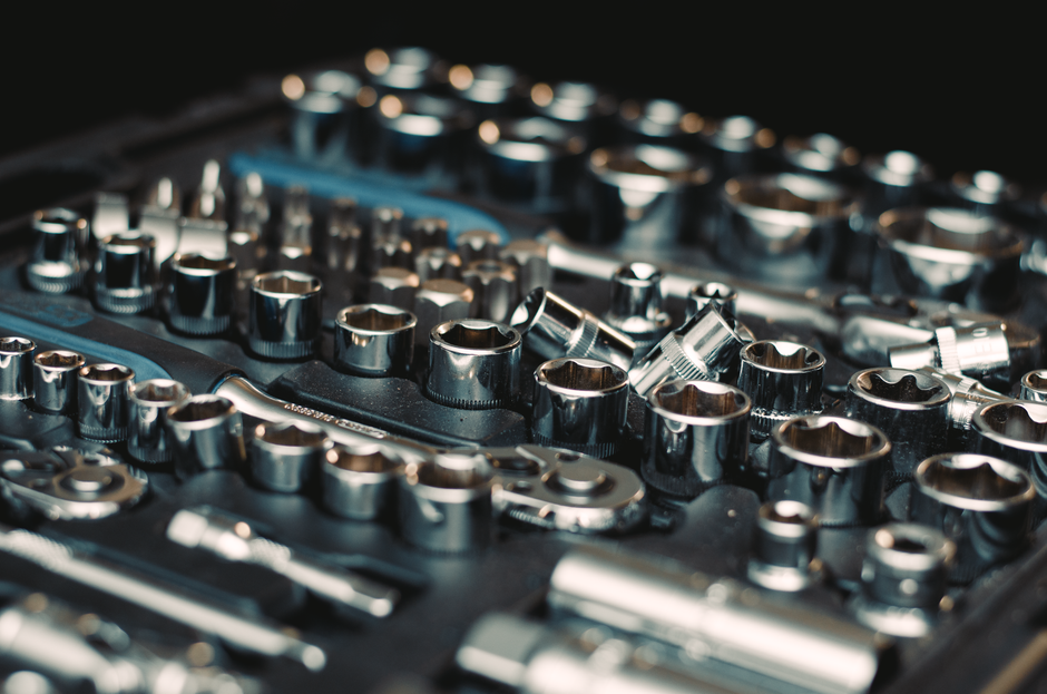 Detailed image of a shiny metal socket wrench set focused on various sizes and shapes.