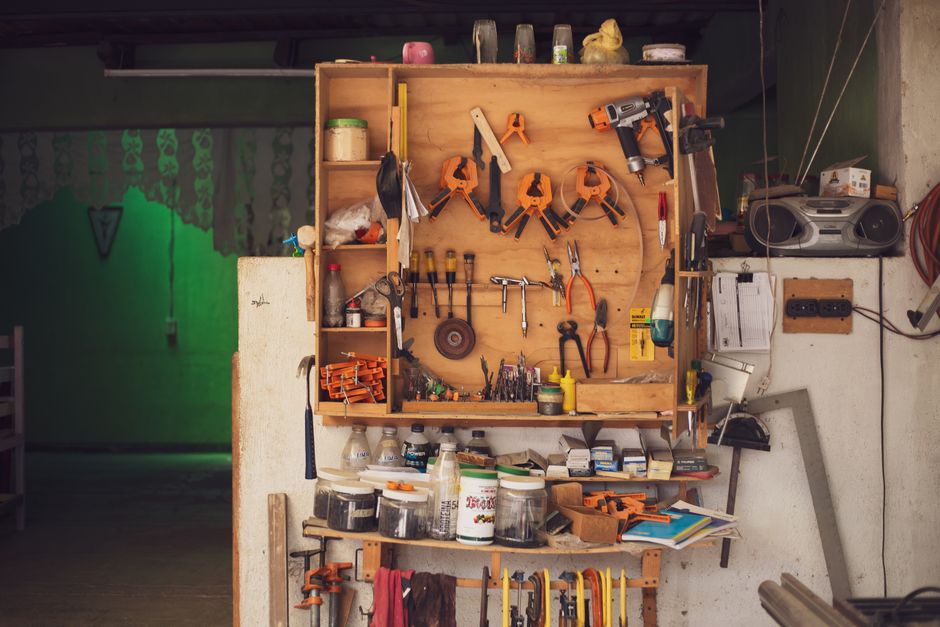A detailed view of an organized workbench with tools in a traditional Mexican carpentry workshop.