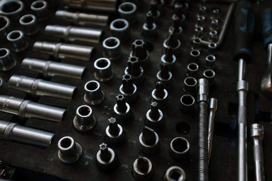 Close-up of assorted metal tools in an organized workshop setting, ideal for mechanical repairs.