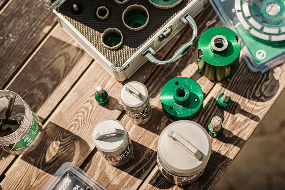 Top view of various tools on a wooden table in sunlight, perfect for equipment repair themes.